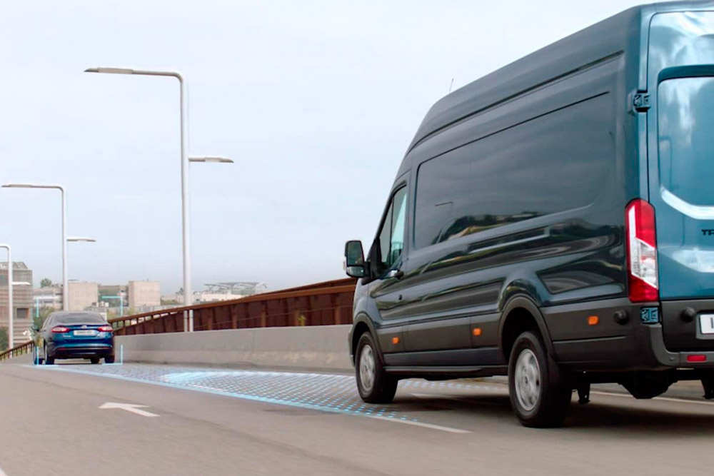 Blue Ford Transit Van with blue lines on road depicting use of Advanced Driver Assistance Systems.